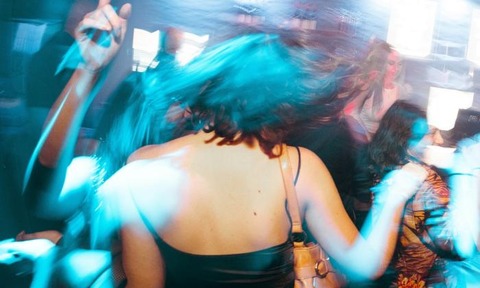 A group of men and women party at the club.