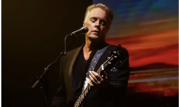 Shaun Cassidy strums his guitar and performs live on stage.