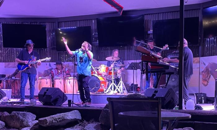 Bandmates from Ultimate Santana performs live on stage.