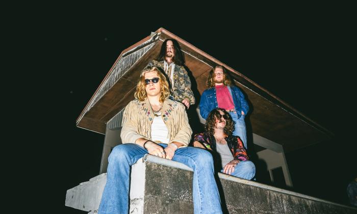 Red Magnolia, a four member band sitting atop a tower