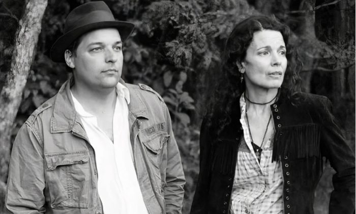 The bandmates of Donna the Buffalo turn their heads in unison, gazing intently at a distant object on the horizon.