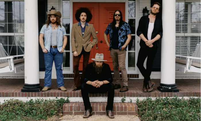 Bandmates from Robert Jon & The Wreck pose on a deck with white pillars.
