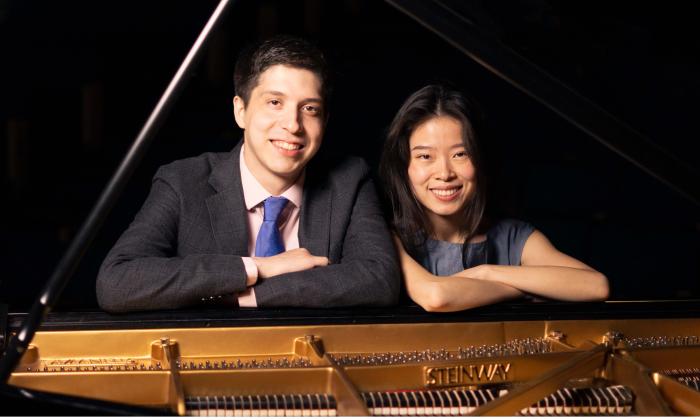 Echo Duo, two pianists, sitting at a Steinway