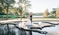Bride and groom posing with public art at World Golf Village