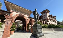 The Henry Flagler statue stands in front of the college's gates