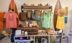 Bright clothing and accessories inside the Stay Sunny shop