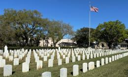 The cemetery grounds with the American flag flying in the background