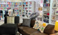 A lounge area with bookshelves lining the walls behind