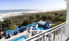 The Tiki Bar and the beach viewed from an upper deck at Guy Harvey Resort