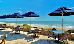 The outdoor dining area at Lynda's at Ocean Club, on a sunny day with blue skies