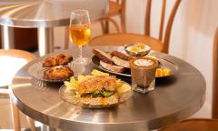 Coffee, wine, pastries, and additional fare on the table