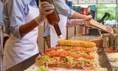 A worker making a sub at Jersey Mike's