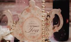 A tea cup with beads dangling over top