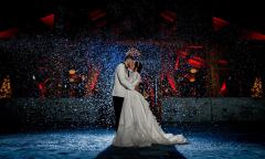 A bride and groom kissing on the dance floor