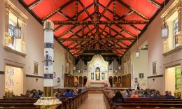 The nave of the Cathedral Basilica of St. Augustine in St. Augustine, Florida. Looking north towards the altar. The ceiling is painted red to honor the city’s Spanish origins, with the seal of each bishop painted on the beams. 