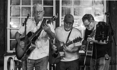 A black and white photo of the band Crab Creek performing. Photo by Derick Grubbs