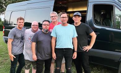 Six members of Smalltown Poets by their tour van