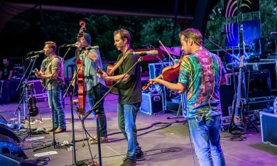 The Yonder Mountain String Band, on stage in bright colors, photo by Dave Vann