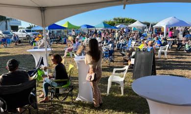 Concert-goers under tents and in the open air on a beautiful October day in Vilano