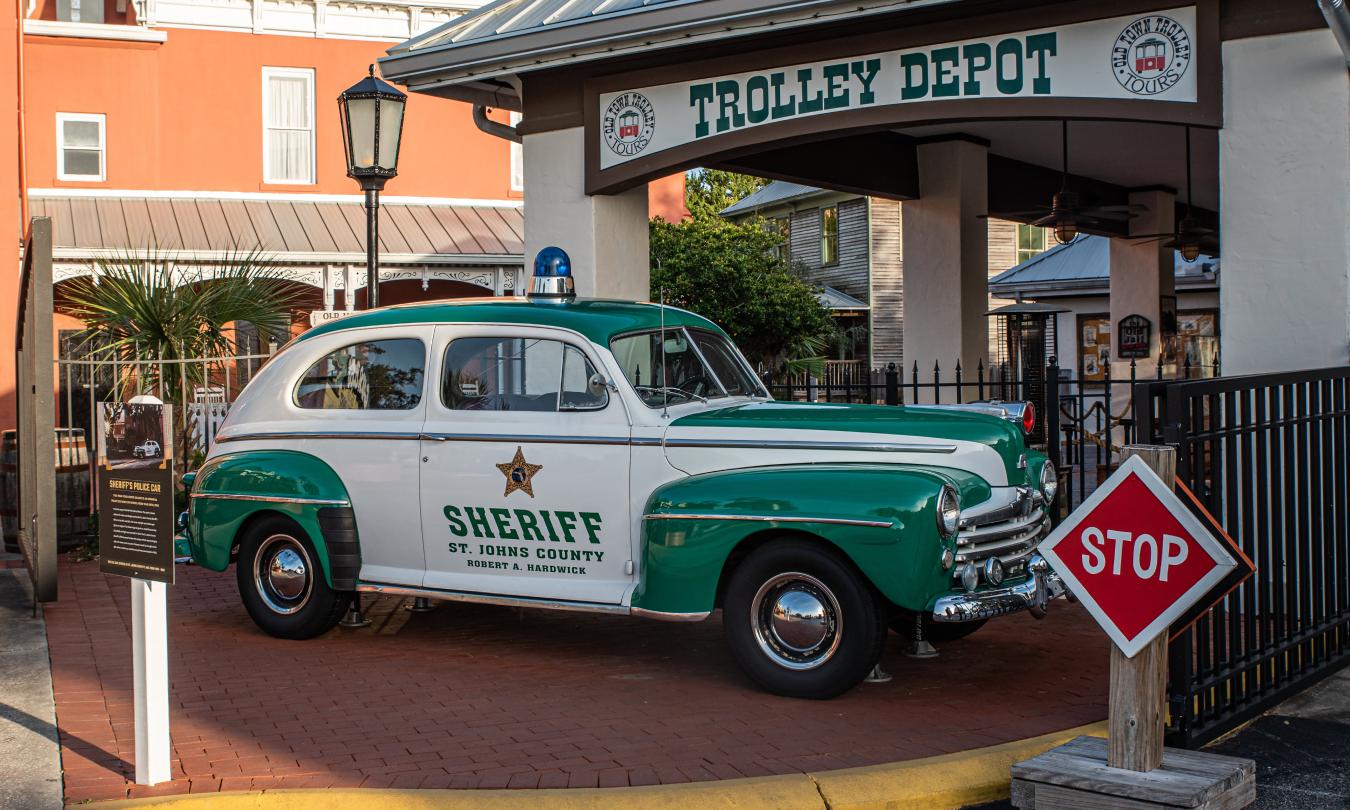 An antique sheriff's car outside of Old Town Trolley's Old Jail in St. Augustine, Florida