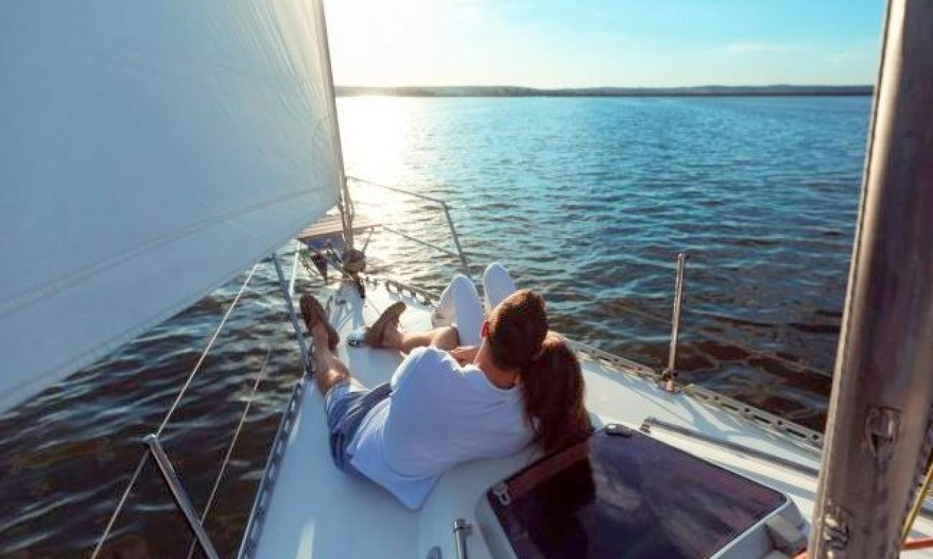 A couple enjoying a romantic sunset sail with St. Augustine Sailing in St. Augustine.