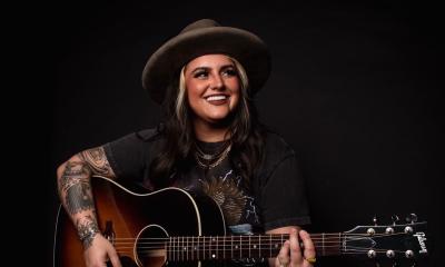Singer songwriter Austin Taylor Dye with her guitar and a big grin. 