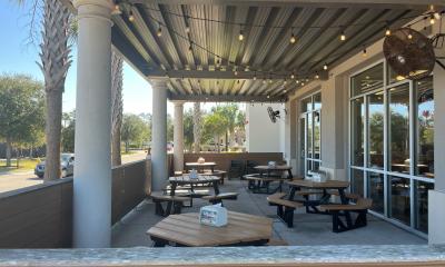 Jersey Mike's Subs covered outdoor patio with tables and chairs in Nocatee town center. 