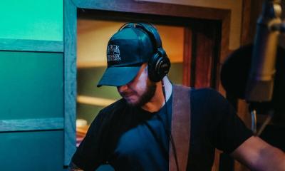 Rob Wiliford wearing a cap and earphones in the studio while recording his album "Wildcard"