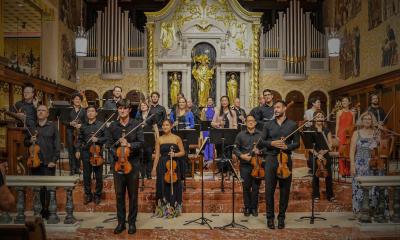 The St. Augustine Music Festival Chamber Orchestra, standing on the Cathedral stage