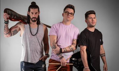 Band members Andy, Miranda, and Leo stand together