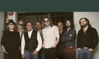 Eagles Revival band standing in front of wood doors