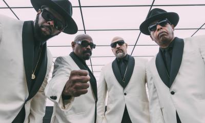 Bandmates from Cypress Hill don white and black suits and pose for fans. 