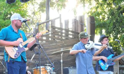 The band Muhly playing onstage outside