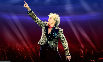 Rod Stewart wears an animal print blazer and performs live on stage.