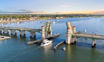A cruising power yacht heading north through the Bridge of Lions, a power y