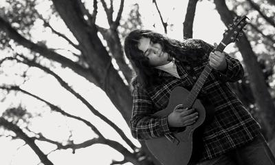Musician Lane Drix in the winter under stark trees