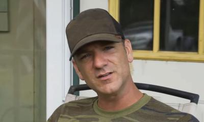 Songwriter Craig Campbell in brown ballcap, on a porch