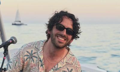 Songwriter Jacob Rice in sunglasses outside, near the ocean