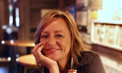 songwriter Marla CAnnon-Goodman sitting inside, smiling