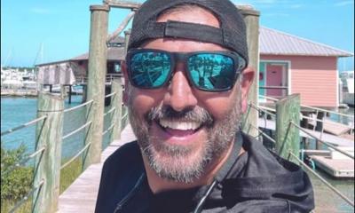 Mike Cook in sunglasses and cap, on a dock