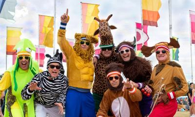 Seven adults dressed in animal costumes and bright sneakers