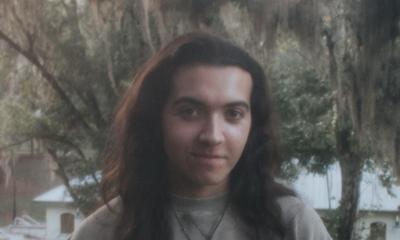 Gainesville musician Alex Willow standing outside
