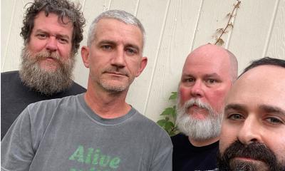 members of the band Loose Toouch, standing outside
