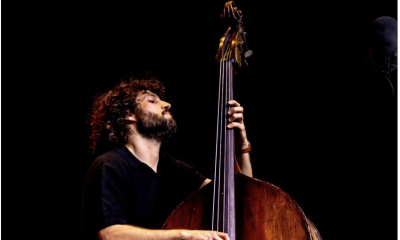 Sam Grisman performs live on stage.