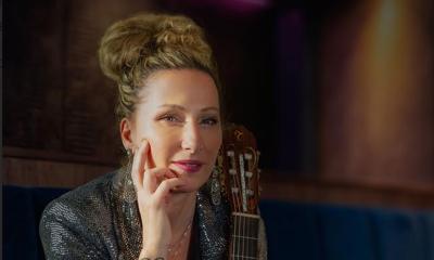 Yael Dray, AKA ZAZA Flamenca, smiling at camers, with hand to chin