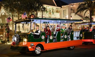 An Old Town Trolley decorated for Nights of Lights with special guests aboard, inluding Santa