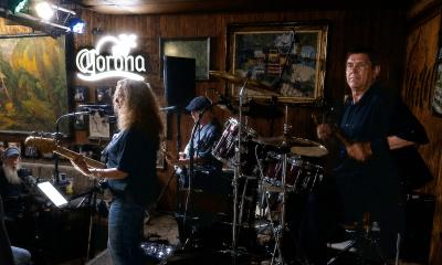 The trio, Ancient City Rock, on stage at TradeWinds Lounge
