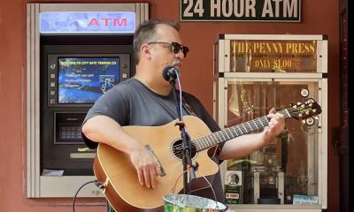 Musician Joe Schauer playing outside in the square at St. George Inn