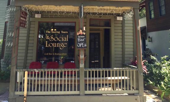 Front of the bar with some outside seating on their porch. 