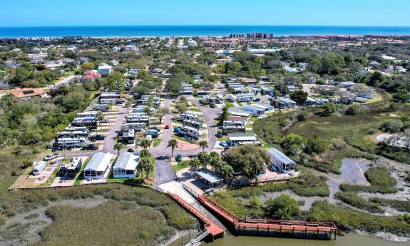 An arial photo showing an RV resort that borders the marsh and is within walking distance of the ocean.